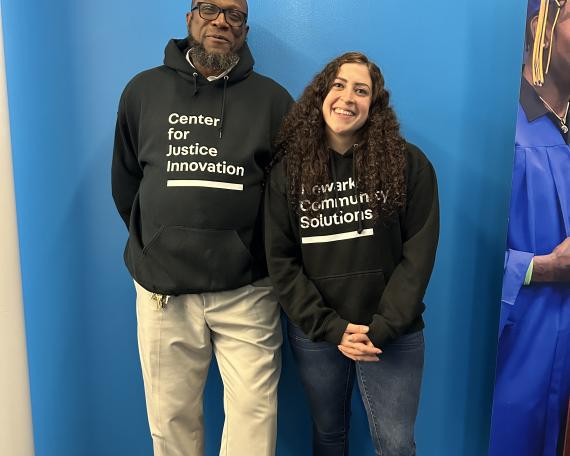 Ella Yenigun and Lorenzo Nash pose for a picture in Center hoodies