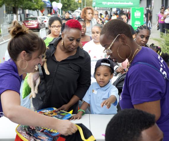 staff giving supplies to child and parent