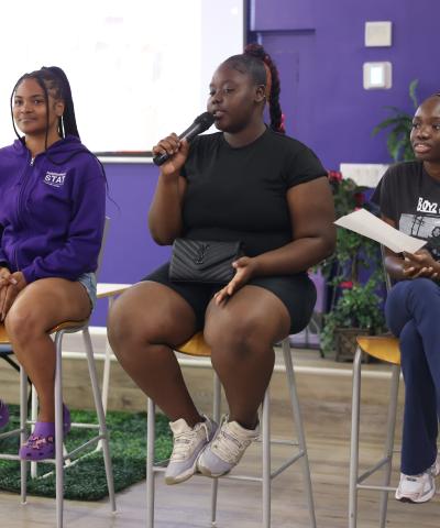 Three young Black women from our community programs in Brooklyn speak at a panel for the Women's Justice Commission's visit to the Brownsville Community Justice Center.