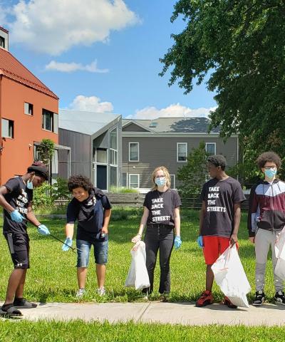 A group of young people participate in a neighborhood clean-up organized by our Syracuse team.