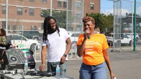 Two of our Queens Community Justice Center staff standing outside at a safety event.