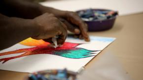 close-up of participant's hands creating artwork at the table during a Project Reset workshop at the Brooklyn Museum