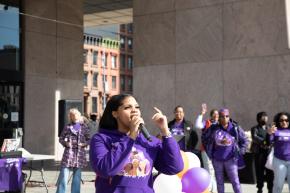 Angelina Rosado of Sisters In Purple speaks at Domestic Violence Awareness Month rally in Harlem.