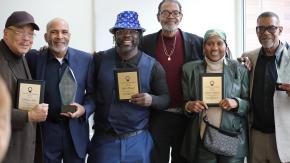 Formerly incarcerated advocates and practitioners pose with awards at our Bronx Community Solutions' reentry forum and resource fair.