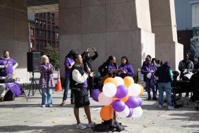 RISE Project Director Heaven Berhane speaks to crowd at Domestic Violence Awareness Month rally in Harlem.