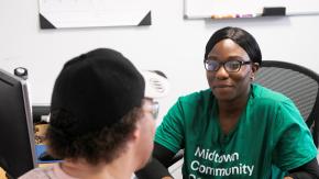 Staff person from Midtown Community Justice Center in a check-in with a client.