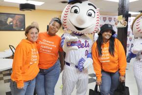 New York Mets mascot Mr. Met poses with staff from Queens Community Justice Center.